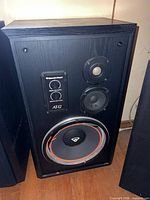 Front view of first speaker showing drivers and control panel