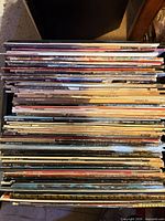 Stack of numerous vinyl LP records in sleeves