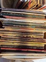Two stacks of vinyl LPs showing spines and quantity