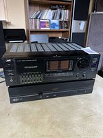Front view of stacked JVC integrated amplifier above Sonance 260 power amplifier