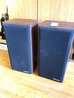 Front view showing both Polk Audio speakers with grilles