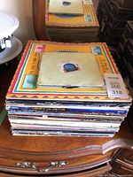 Full stack of albums and singles on furniture