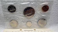 Front view of sealed 1976 proof-like coin set showing obverse sides of six coins