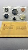 Full view of sealed six-coin 1985 RCM set with information card