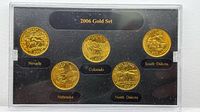Front view of display case with five gold-layered quarters