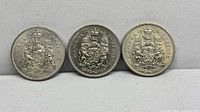 Front view of three coins 1969, 1979, 1980