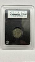 Front view of encapsulated ancient Roman bronze coin with INB certification label visible