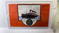 Front of display with Titanic image and embedded coin