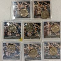 Seven of the eight sleeved 1963 Jefferson nickels displayed on surface