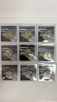 Nine individually sleeved Ocean in View nickels