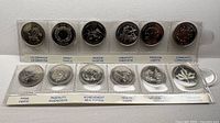 Full view of 12-coin Millennium quarter set in sleeve