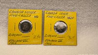 Both 1902 Canadian silver 5-cent coins in yellow 2×2 holders