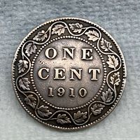 Reverse side showing maple leaf vine and 1910 date