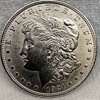 Obverse view of 1921 Morgan silver dollar showing Liberty head and date