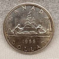 Reverse of 1966 Canadian silver dollar showing Voyageur design and date