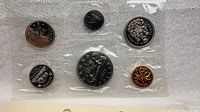Obverse sides of six 1972 Canadian coins in sealed mint cellophane