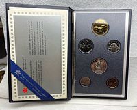 Open case showing six specimen coins and certificate page