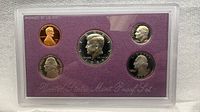 Front view of sealed proof set showing all five obverse designs