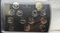 Front view of full 13-piece Millennium coin set in display case