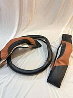 Steering wheel cover and two seatbelt pads laid out