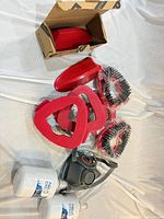 Overview of respirator, water filters, red attachments, boxed scoop