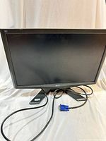 Front view of Acer X193W b monitor on stand with attached VGA cable visible