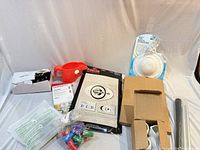 All items laid out: filter box, Delta package, izolor kit, door knob box, red cup, stampers, black tubes, white disc