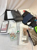 Group view of assorted packaged phone cases, wallet case, accessories