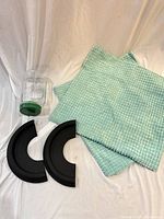 Group shot: jar, two black semicircular pieces, two mint pillow covers