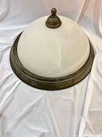 Full side view of dome fixture showing glass shade and metal trim