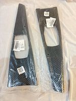 Both carbon-fiber style panels packaged in clear plastic