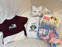 All items laid out together showing jersey, towel, diapers, collars, mask