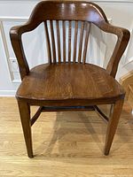 Front view of oak banker chair showing overall design