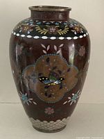 Front view of vase showing butterfly cartouche and floral motifs