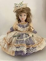 Front view displaying full doll and fabric skirt