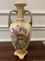 Full view of vase front showing shape, handles, painted motif