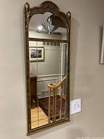 Full front view showing arched mirror, frame, etched panels and green base detail