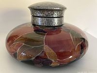 Front view of Moorcroft Pomegranate ink well showing silver collar and lid