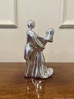 left profile of polished aluminum Hoselton abstract couple sculpture