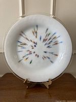 Front view of fused glass charger on stand