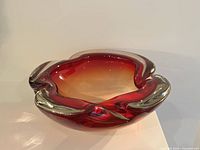 Oblique view showing red glass exterior and amber interior with petal rim