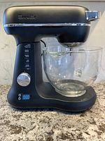 Full view Breville stand mixer with glass bowl on countertop