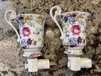 Both porcelain floral teacup night lights side by side