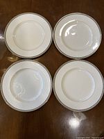 All four matching dinner plates displayed