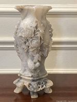 Full view of carved soapstone vase showing overall design and root-form base