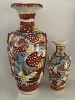 Front view of both Satsuma vases showing painted figures and sizes