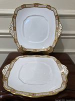 both square Royal Albert gilded serving plates front view