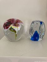 Both paperweights side by side showing overall forms