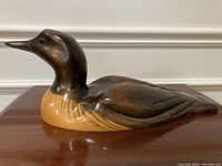 Left side profile of carved loon showing overall form and finish