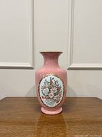 Full front view of pink porcelain vase with floral medallion